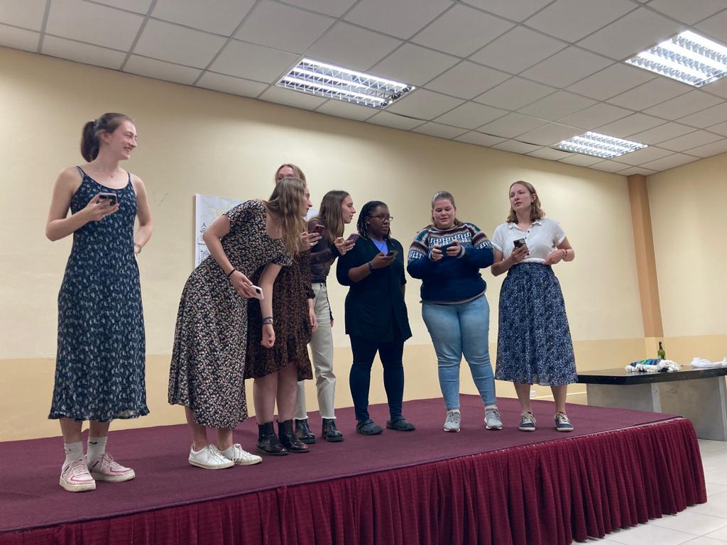 Students performing or singing together on stage.
