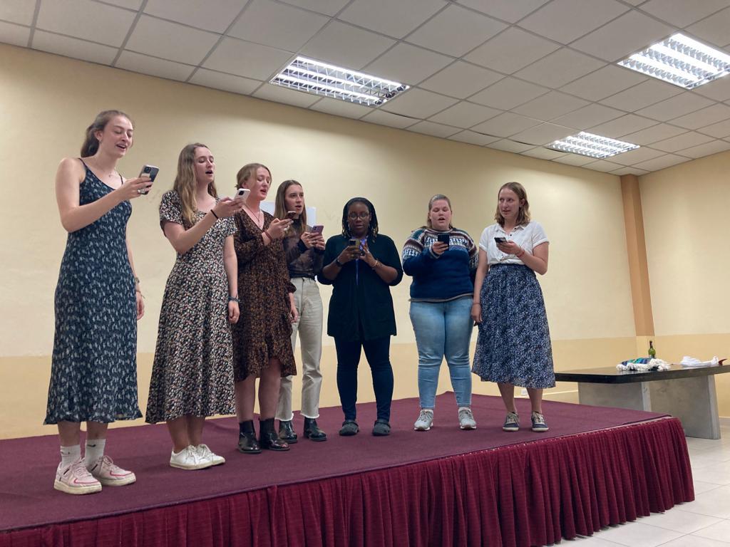 A group of students standing on stage during a presentation.
