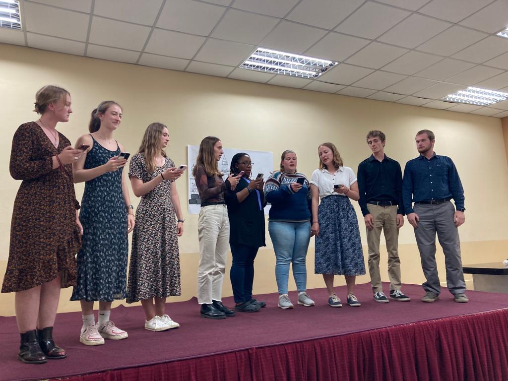 A line of students standing together on stage.
